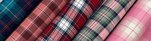 Plaid flannel fabrics in navy, burgundy, pink, and green — cozy deadstock fabric by the yard for fall sewing.
